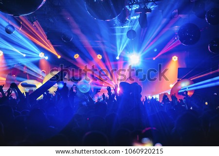 dj night club party rave with crowd in music festive Royalty-Free Stock Photo #1060920215