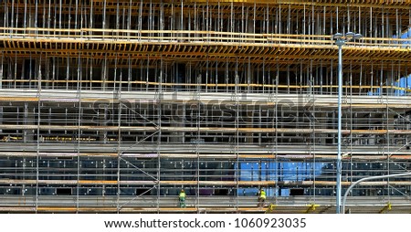 Construction site. Scaffolding. Building frame. Exterior of unfinished building. Modern civil engineering. Construction industry. Close up. 