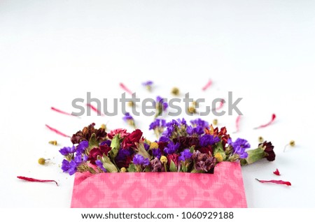 Dried flowers in pink envelope