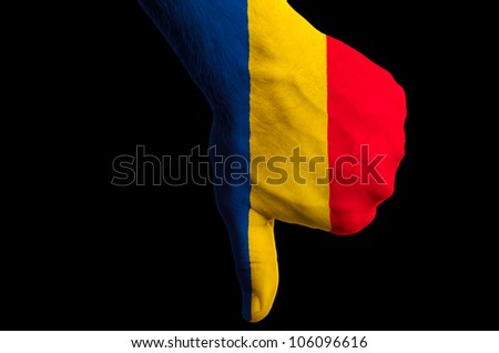 Hand with thumb down gesture in colored romania national flag as symbol of negative political, cultural, social management of country