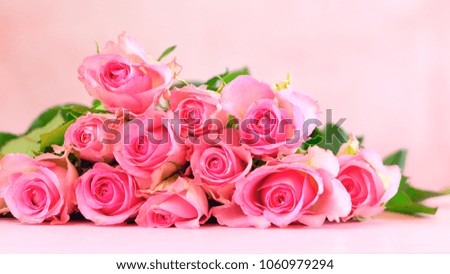 Pink roses on pink wood table, Happy Mother's Day background closeup with copy space.