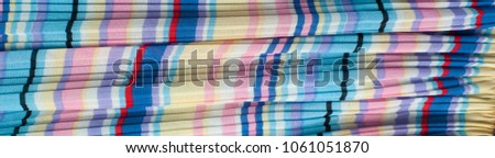 Pleated fabric. Sinii yellow red white stripes texture. Photography Studio