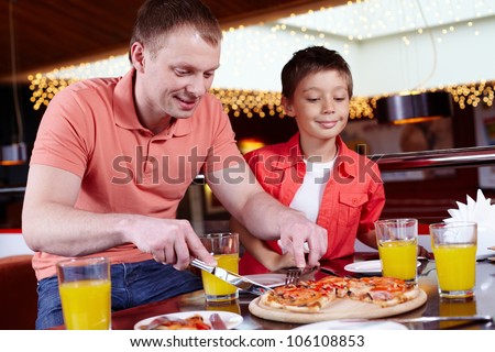 Father and son having a party for men only at the pizzeria