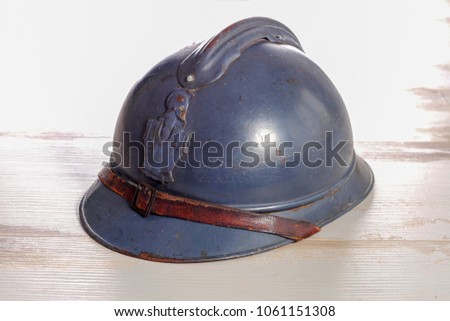 a french military helmet of the First World War on the wooden table Royalty-Free Stock Photo #1061151308