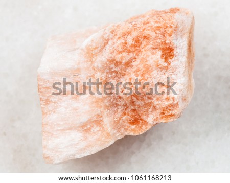 macro shooting of natural mineral rock specimen - rough Selenite stone on white marble background from Vodinskoye mine in Samara Region of Russia Royalty-Free Stock Photo #1061168213
