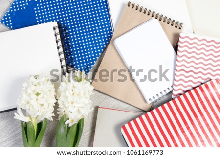 Flowers composition with white hyacinths with notebook. Spring flowers on white background. Easter concept.