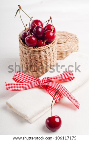 Festive table setting and decoration with fresh flowers and sweet cherry