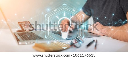 Graphic designer on blurred background using lightbulb idea interface 3D rendering