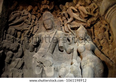 Hindi gods hand-made scriptures on walls in historic and centuries old elephanta caves in mumbai, india  Royalty-Free Stock Photo #1061198912