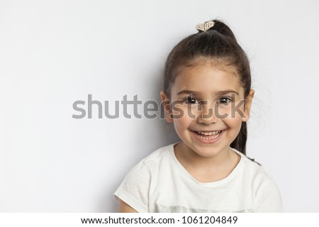Portrait of a happy smiling child girl Royalty-Free Stock Photo #1061204849
