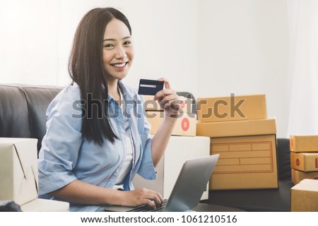Young asian pretty girl using credit card and laptop computer for shopping online at home, Cyber Monday
