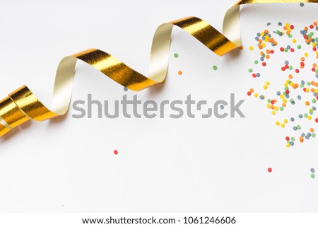 Overhead image with various colorful party accessories on white background with copy space