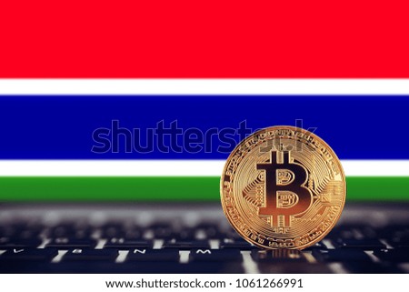 Gold Bitcoin on background of chart Gambia flag.
