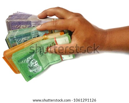 Bundle of money in hand. Malaysia Ringgit (MYR) RM100, RM50, RM20, RM5 with isolated white background