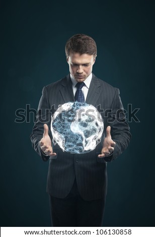 man holds in  hands an abstract Earth