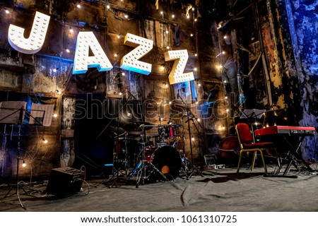 Jazz Music Concert Stage Night Light Decoration Beautiful Vintage  Gloving Bulbs Lights Letters Musical Instruments Music Notes Red Piano Objects Darkness Old Interior Wall Royalty-Free Stock Photo #1061310725