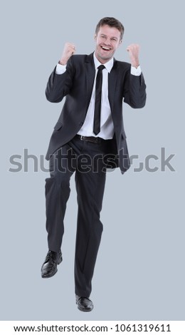 Full length of happy successful manager smiling isolated on gray