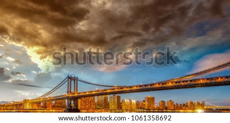 Amazing sunset view of Manhattan Bridge with East River reflections - New York City.