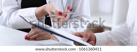 Female doctor hand hold silver pen and showing pad. Physical agreement form signature disease prevention ward round reception consent contract sign prescribe remedy healthy lifestyle concept