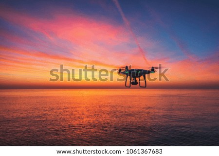 Beautiful morning over the sea and flying drone.