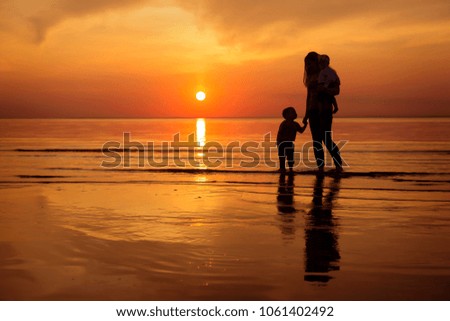 family on sunset by the sea 