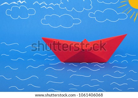 Paper ship on waves. 