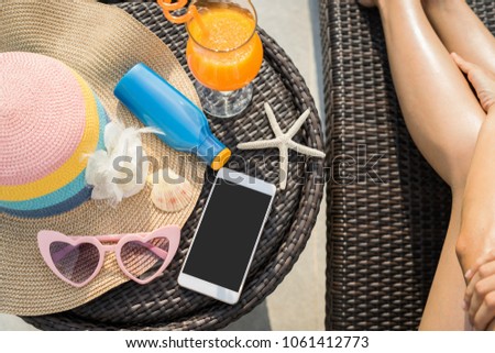 Young woman wearing swimsuit relaxing at swimming pool with smartphone and copy space, Summer vacation concept