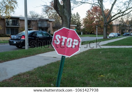 A stop sign is a traffic sign to notify drivers that they must come to a complete stop and make sure no other cars are coming before proceeding