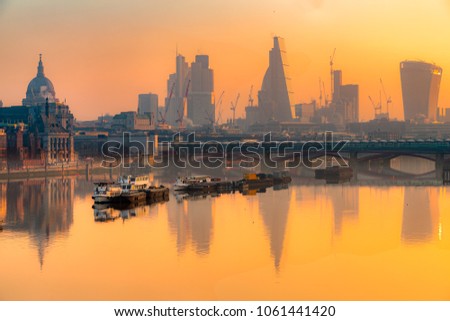 City of London skyline at sunrise with St. Paul basilica and modern skyscarpers, London, UK