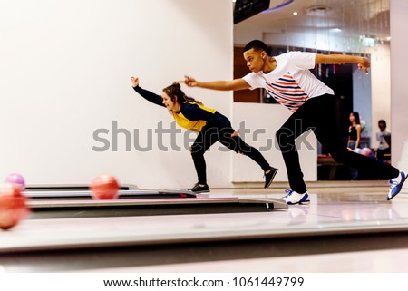 Teen boys bowling together