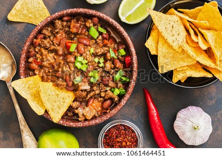 Mexican food dish chili con carne. The concept of Mexican cuisine. Top view, old, rusty background Royalty-Free Stock Photo #1061464451