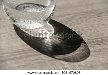 vase with water in air bubbles horizontal on the table flare close-up
