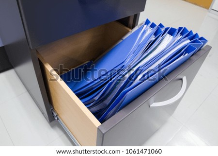 Blue file folder documents In a Filing cabinet for Keep the important Document,  concept office equipment