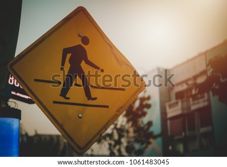 Walking sign to symbolize the safety of people from car accidents.