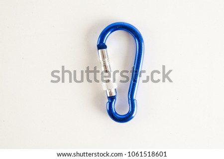 Metal aluminum snap hook isolated background Safety lock carabiner for rope climbing Royalty-Free Stock Photo #1061518601