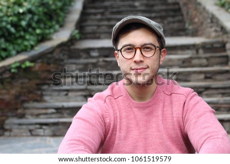 Hip ethnic man wearing eyeglasses and hat Royalty-Free Stock Photo #1061519579