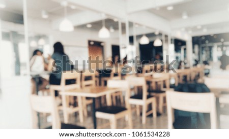 group of asian teenager students are reading books and working at cafe on weekend, blurred background