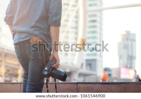 Photographers holding camera with Thailand tourist.
