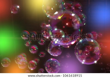 Abstract image of soap bubbles from the bubble blower in dark.
