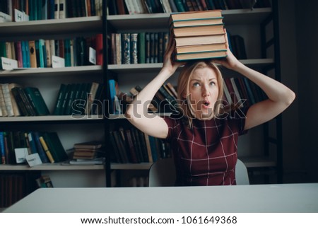 Young beautiful blond student girl with books