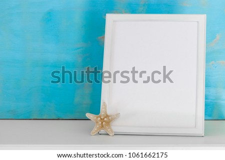 Mockup with white frame and star fish with a turquoise rustic background