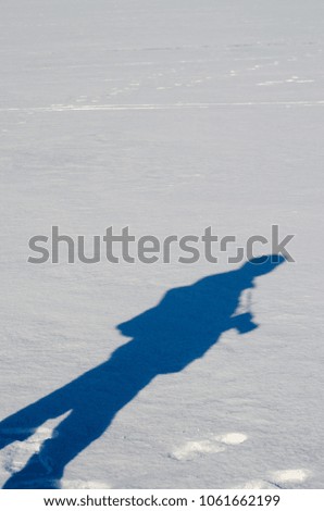Shadow of the photographer on the bright snow. 