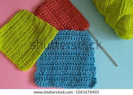 Crochet. Ball of green thread with a crochet hook. Balls of woolen threads and knitting needles. Threads for knitting.