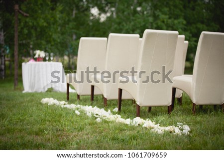 Wedding set up in a garden. Wedding ceremony & Wedding decorations/Wedding Archway/Wedding Archway with white petals on the grass