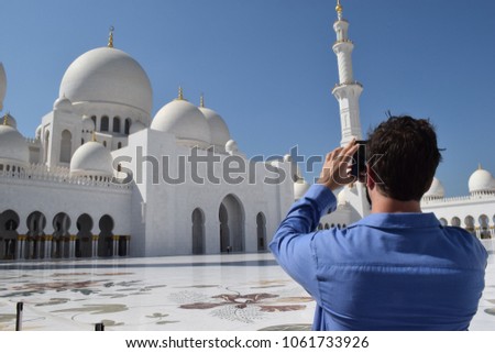 Sheikh Zayed Mosque - A man taking picture of the building with his mobile phone. 