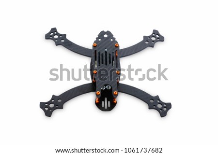 The beginning of the racing drone assembly. A robust frame of an unmanned aerial vehicle made of carbon fiber. Frame of carbon fiber quadrocopter isolated on white background.
