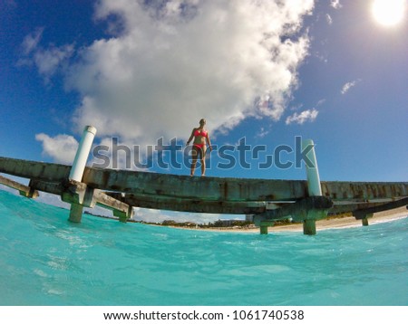 Woman standing on pier at Grace Bay