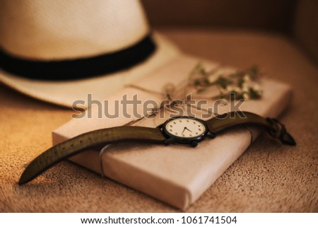 Flatlay of summer straw hat, retro hand watches and a book. Traveler items, vacation travel accessories, holiday weekend, day off, travelling stuff, equipment background, view concept
