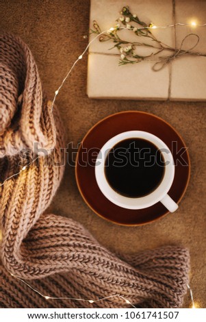 A cup of coffee and a book on a plaid. Sweet home. Good morning. Reading and home relaxation concept. Top view, flat lay