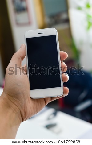 Close up on hand using mobile phone with blank copyspace display for advertising text message or content mockup background. Professional payment technology, game playing, video filming or photography